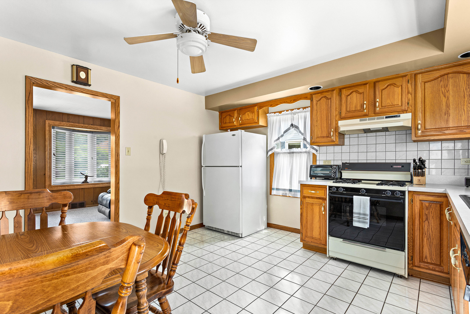 11133 Revere Road Mokena, IL 60448 - Photo 10 of 22 a kitchen with stainless steel appliances granite countertop a stove a refrigerator a dining table and chairs with wooden floor