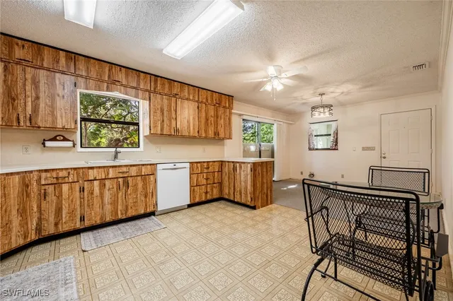 a kitchen with a refrigerator sink stove and cabinets