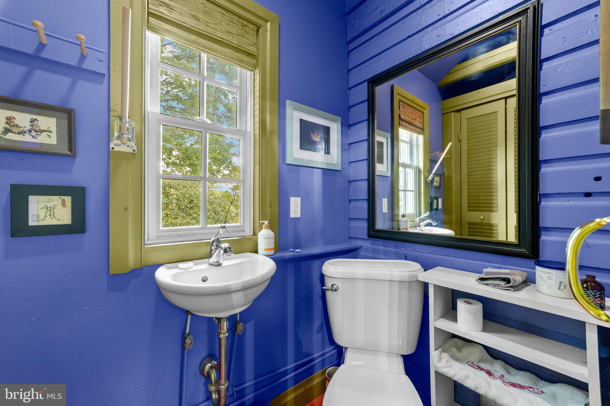 327 East Street Road Kennett Square, PA 19348 - Photo 21 of 41 a bathroom with a sink a toilet and mirror