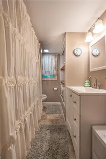 a bathroom with a sink a mirror and a shower