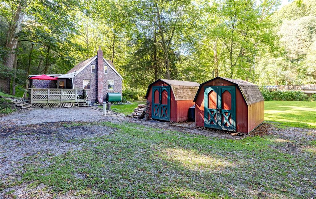 1360 Abers Creek Road Monroeville, PA 15146 - Photo 17 of 20 a view of backyard with wooden fence and a large tree