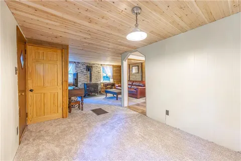 a view of a livingroom with a chandelier furniture and windows