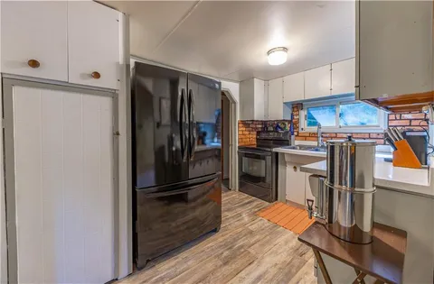 a kitchen with stainless steel appliances granite countertop a refrigerator and a stove