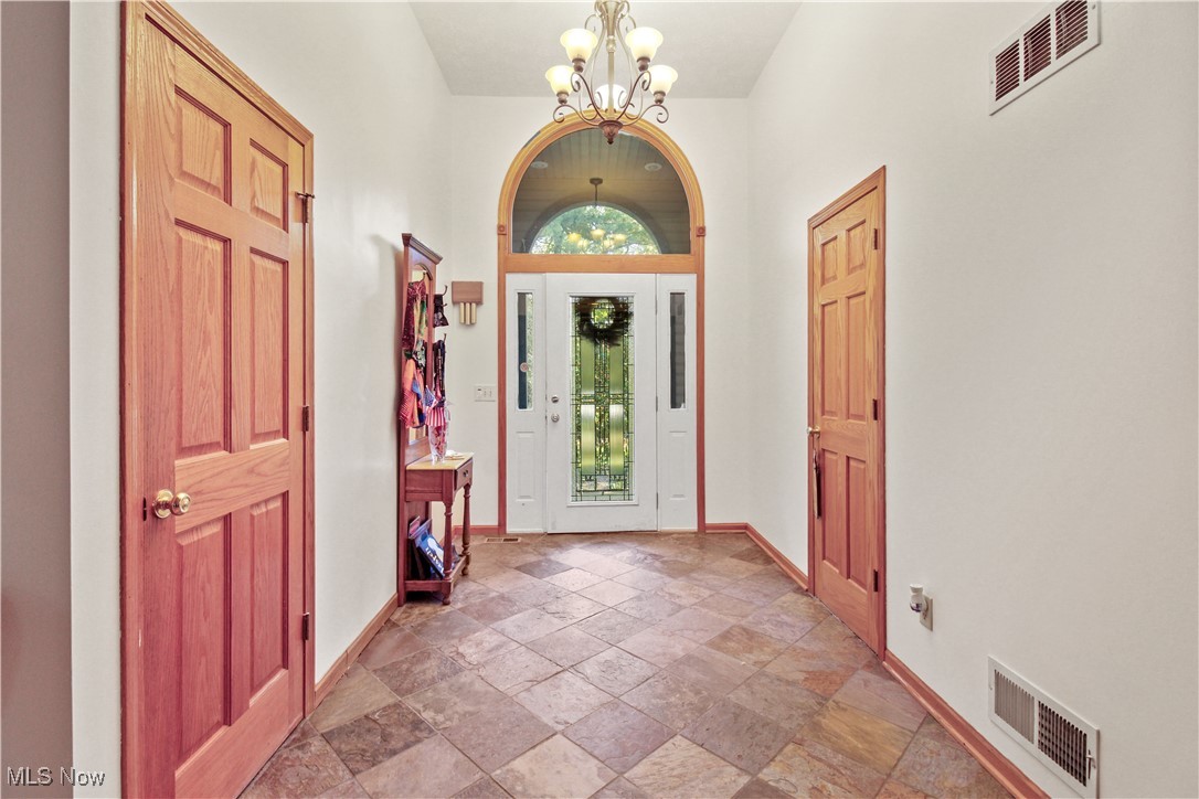 2632 Berry Road Akron, OH 44320 - Photo 5 of 39 Foyer entrance featuring a notable chandelier