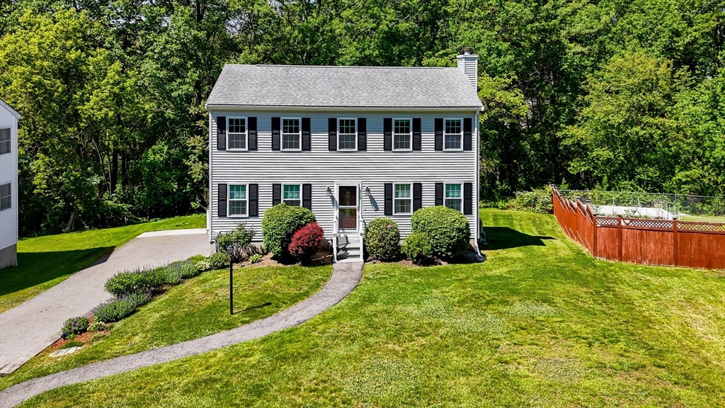 218 Acropolis Road Lowell, MA 01854 - Photo 1 of 39 a view of a house with a yard patio and a garden