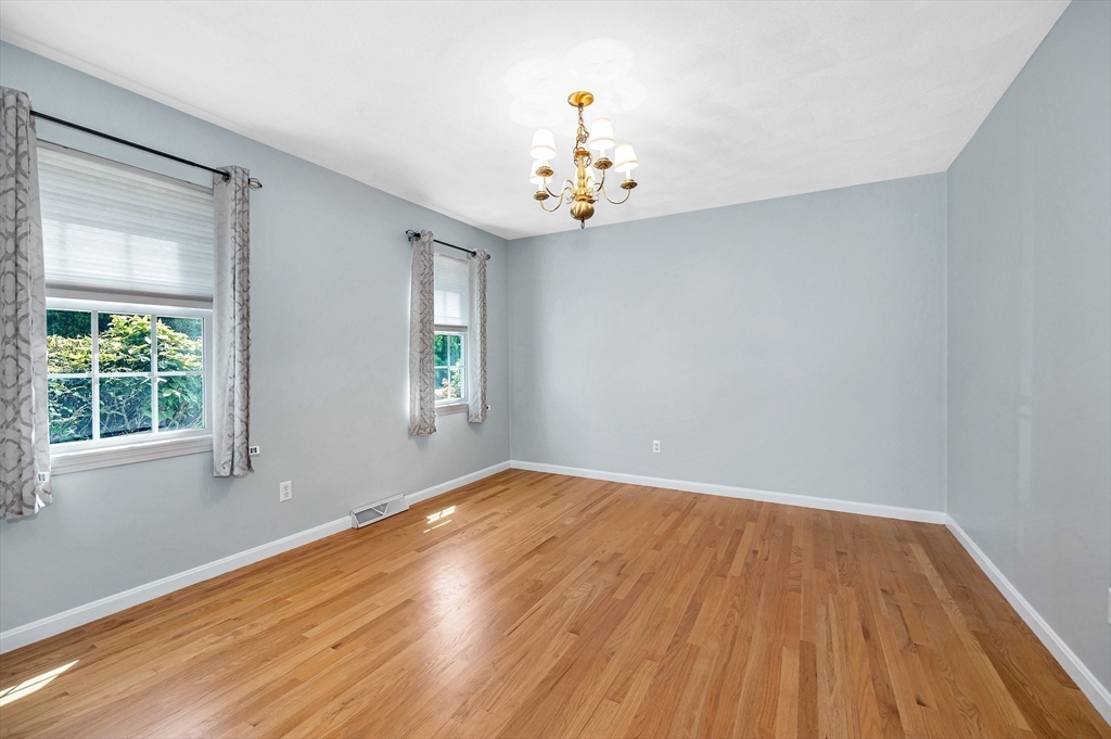 218 Acropolis Road Lowell, MA 01854 - Photo 17 of 39 a view of an empty room with wooden floor and a window
