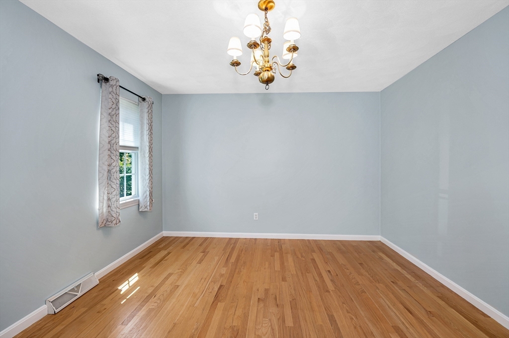 218 Acropolis Road Lowell, MA 01854 - Photo 18 of 39 a view of empty room with wooden floor and fan