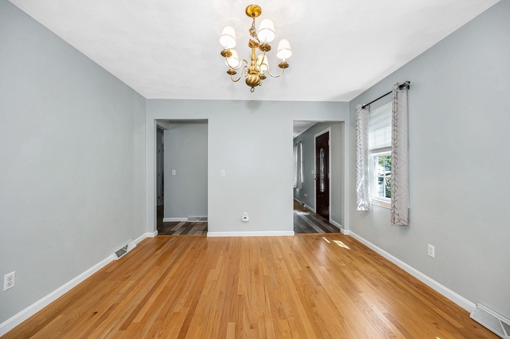 218 Acropolis Road Lowell, MA 01854 - Photo 19 of 39 a view of a room with wooden floor and chandelier