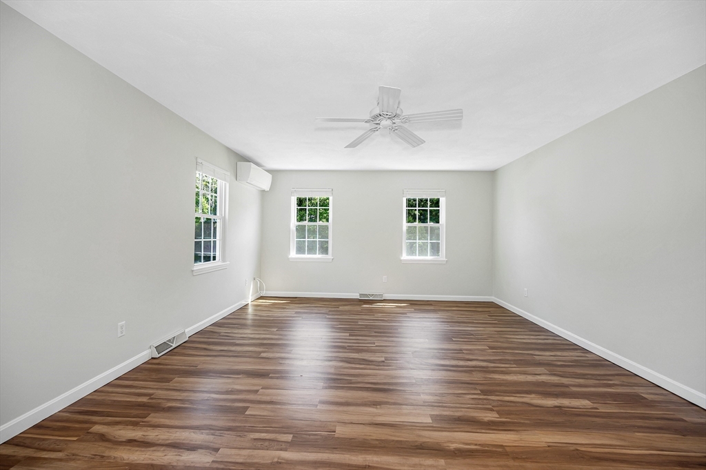 218 Acropolis Road Lowell, MA 01854 - Photo 20 of 39 a view of an empty room with wooden floor and a window