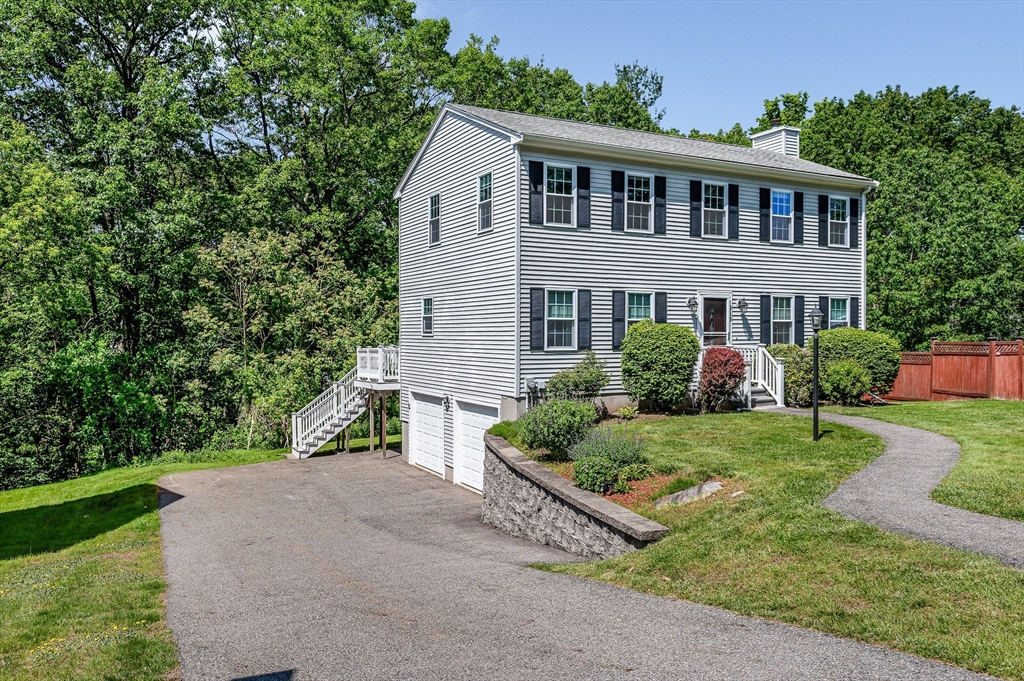 218 Acropolis Road Lowell, MA 01854 - Photo 2 of 39 a front view of a house with a yard