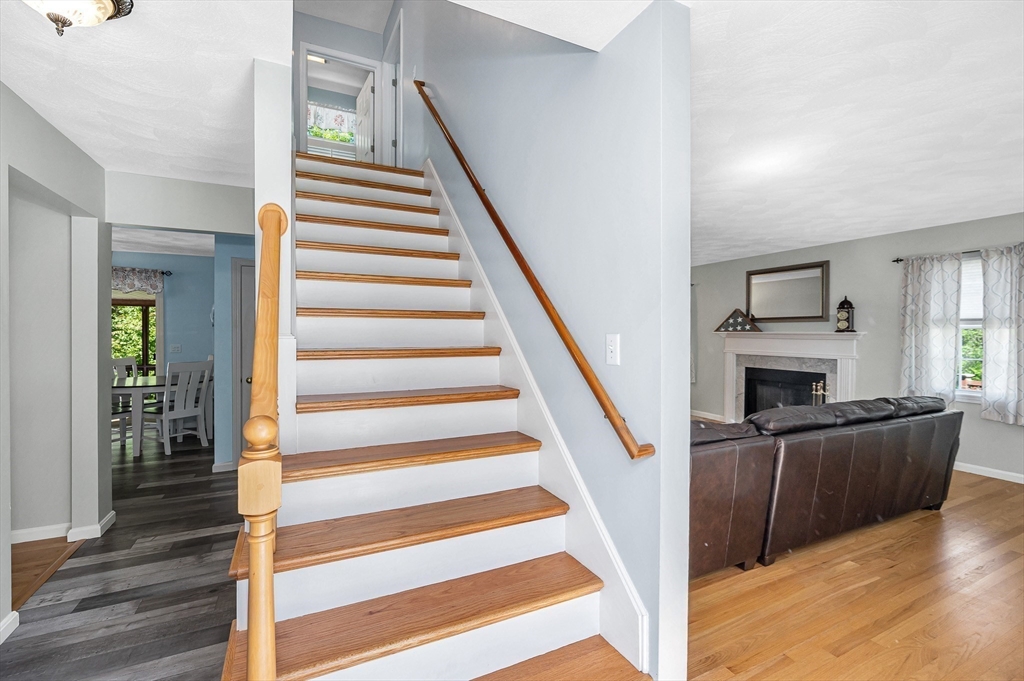 218 Acropolis Road Lowell, MA 01854 - Photo 3 of 39 a view of a livingroom with wooden floor and furniture