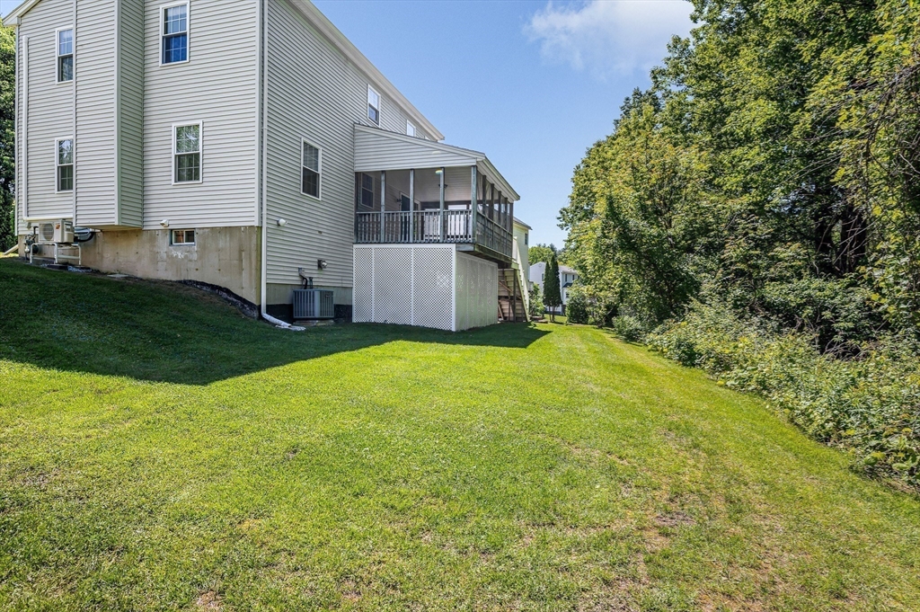 218 Acropolis Road Lowell, MA 01854 - Photo 35 of 39 a view of a house with a yard