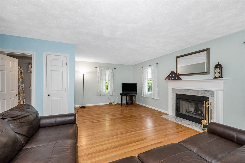 218 Acropolis Road Lowell, MA 01854 - Photo 5 of 39 a living room with furniture and a fireplace