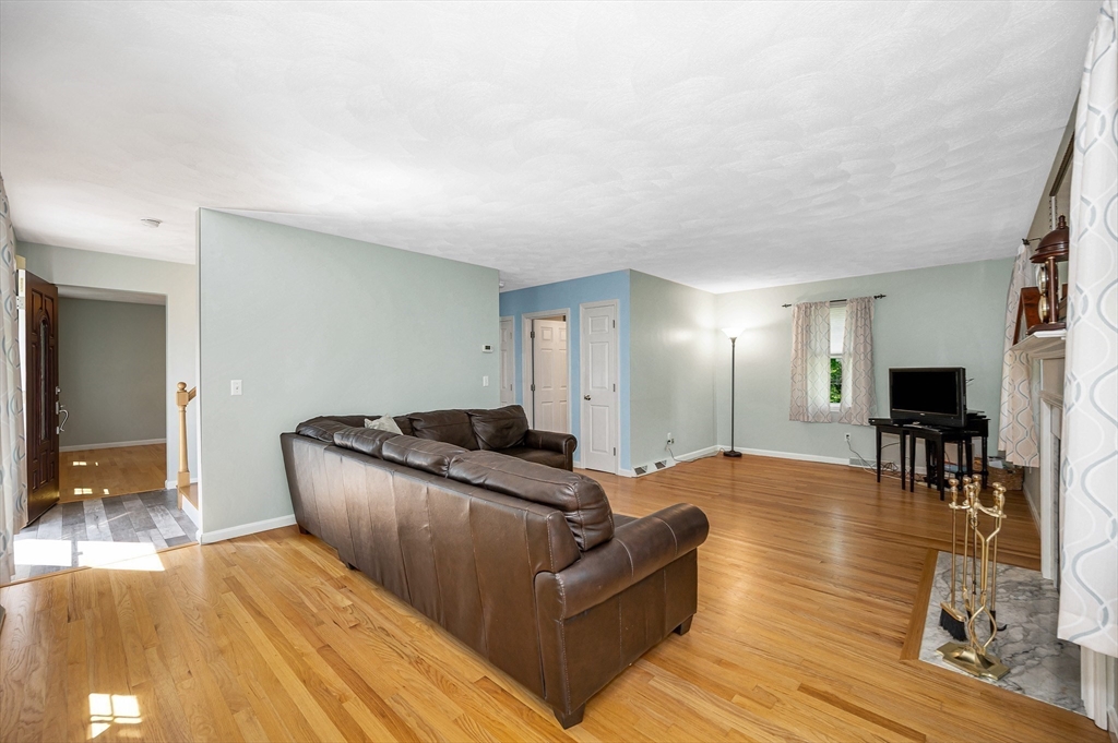 218 Acropolis Road Lowell, MA 01854 - Photo 7 of 39 a living room with furniture and a wooden floor