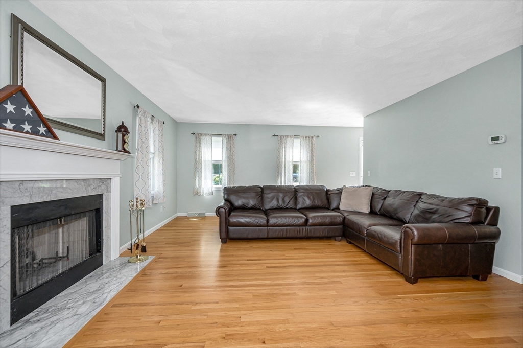 218 Acropolis Road Lowell, MA 01854 - Photo 8 of 39 a living room with furniture and a fireplace