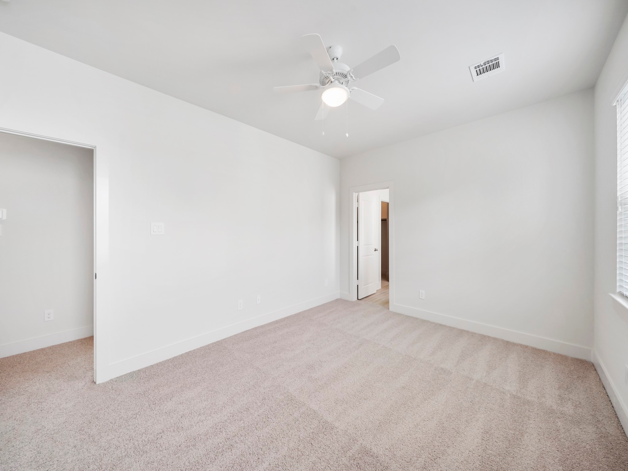 2007 Bauer Drive, Unit A Houston, TX 77080 - Photo 23 of 35 an empty room with a ceiling fan and window