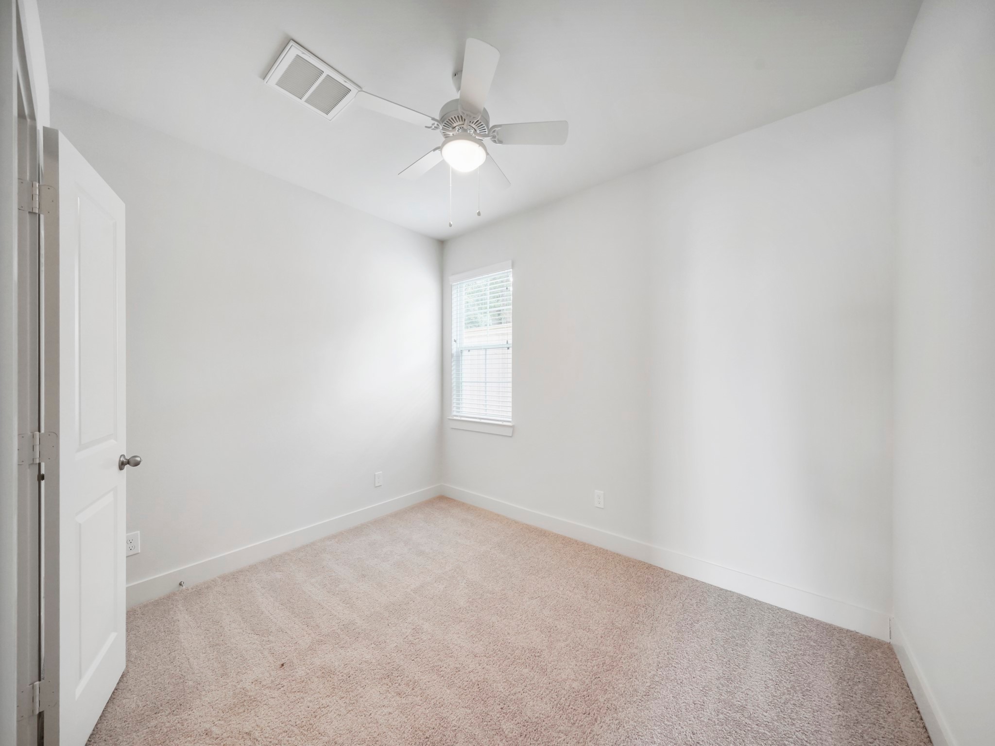 2007 Bauer Drive, Unit A Houston, TX 77080 - Photo 6 of 35 an empty room with a chandelier fan and windows