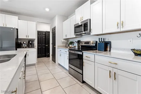 a kitchen with stainless steel appliances a sink a stove a microwave and cabinets