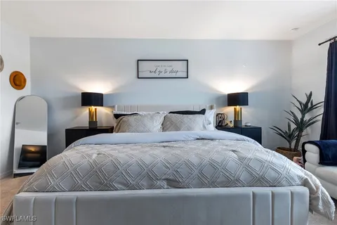 a bedroom with a bed and lamp
