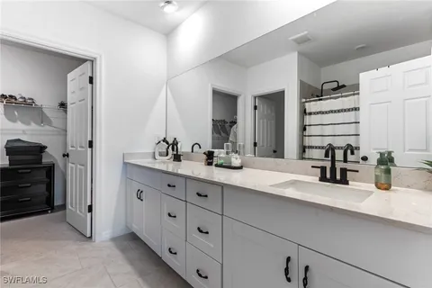 a bathroom with a double vanity sink and a mirror