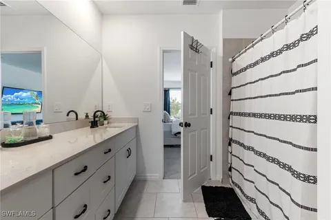 a bathroom with a double vanity sink and mirror