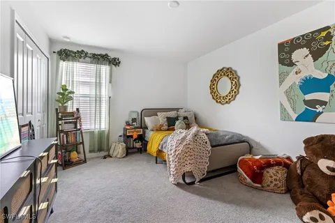 a bedroom with bed and a window