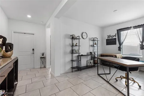 a room with furniture a flat screen tv and a window