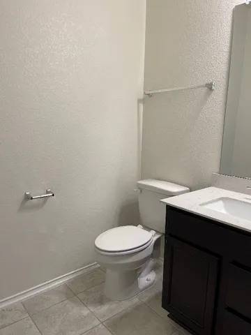 a bathroom with a sink a toilet and vanity