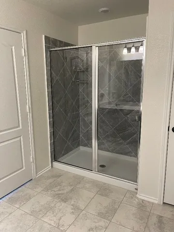 a bathroom with a glass shower door