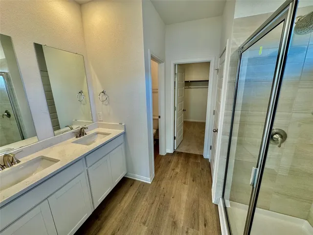 a bathroom with a double vanity sink and a mirror