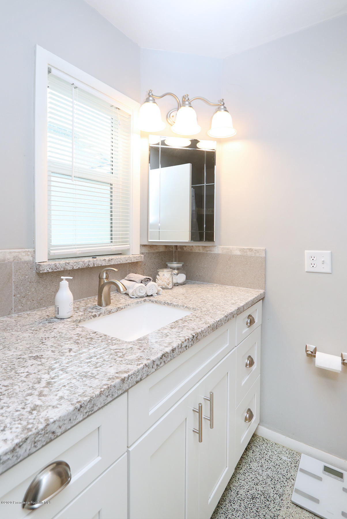 1867 Layton Street Pasadena, CA 91104 - Photo 10 of 22 a bathroom with a granite countertop sink and mirror