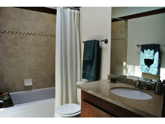 500 West Middlefield Road, Unit 154 Mountain View, CA 94043 - Photo 11 of 16 a bathroom with a granite countertop sink a mirror and a bathtub
