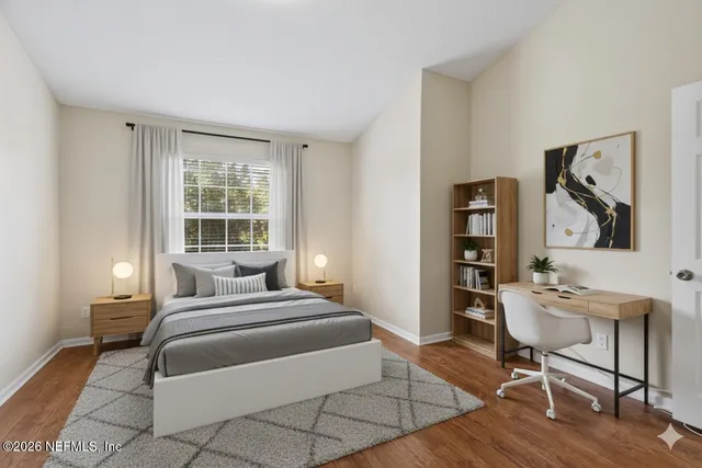 a bedroom with a bed and a table in it