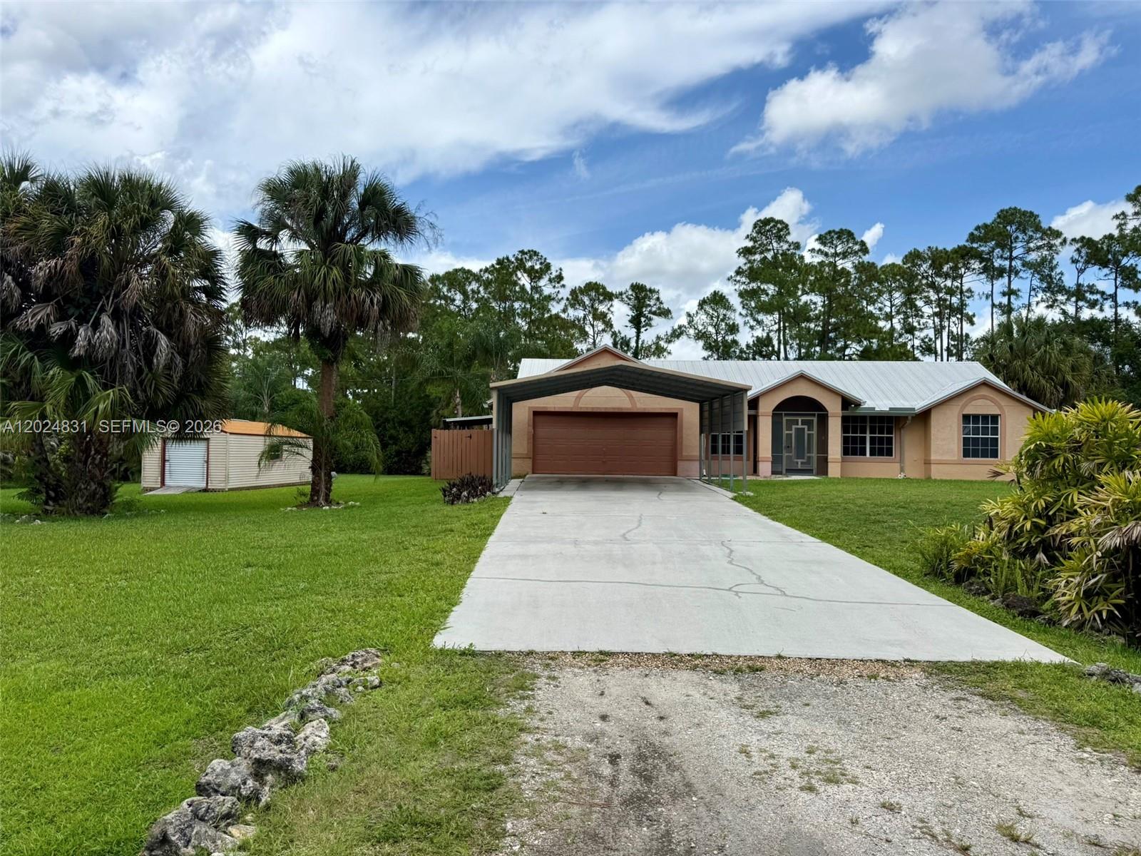 15819 76th Road North Loxahatchee, FL 33470 - Photo 3 of 45 a front view of a house with a yard