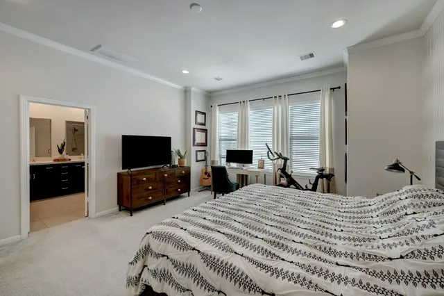 a bedroom with a bed and a television