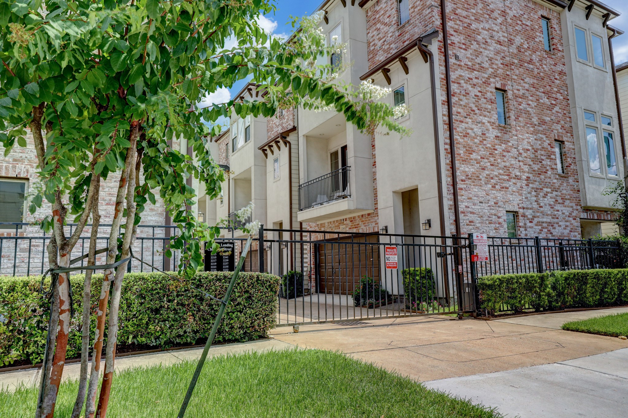 2231 Chenevert Street Houston, TX 77003 - Photo 26 of 26 a view of a brick house with a yard plants and large tree