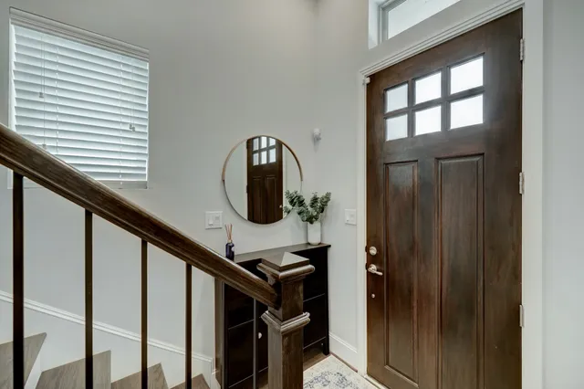 a view of entryway and hall with wooden floor