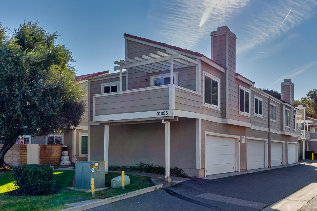 31355 The Old Road, Unit E Castaic, CA 91384 - Photo 1 of 38 a front view of a house with a yard