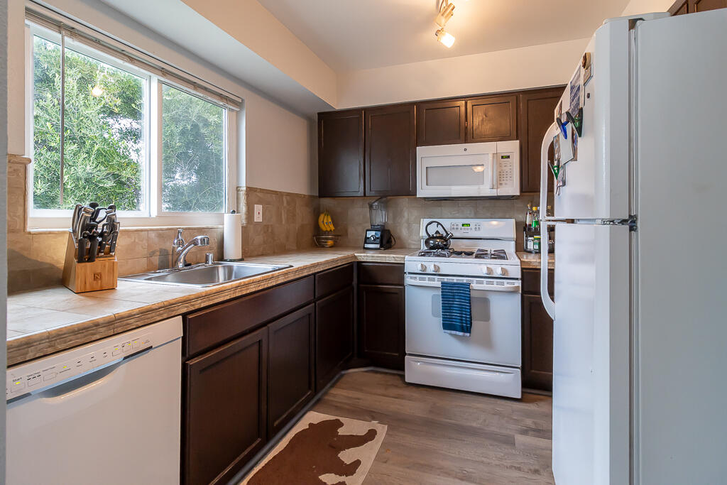 31355 The Old Road, Unit E Castaic, CA 91384 - Photo 13 of 38 a kitchen with stainless steel appliances granite countertop a refrigerator sink and stove