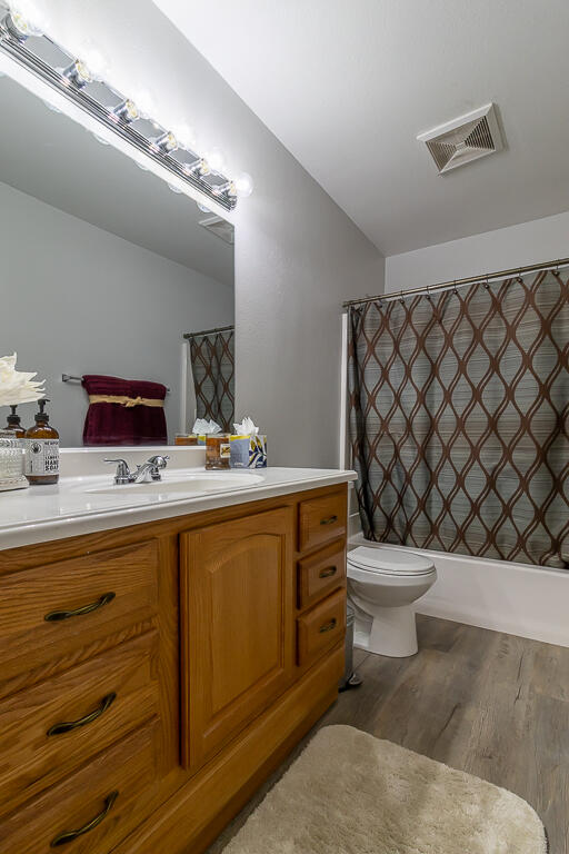31355 The Old Road, Unit E Castaic, CA 91384 - Photo 23 of 38 a bathroom with a toilet a sink and a mirror