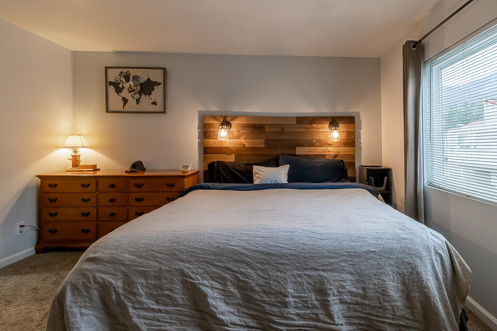 31355 The Old Road, Unit E Castaic, CA 91384 - Photo 25 of 38 a bedroom with a bed and a chandelier