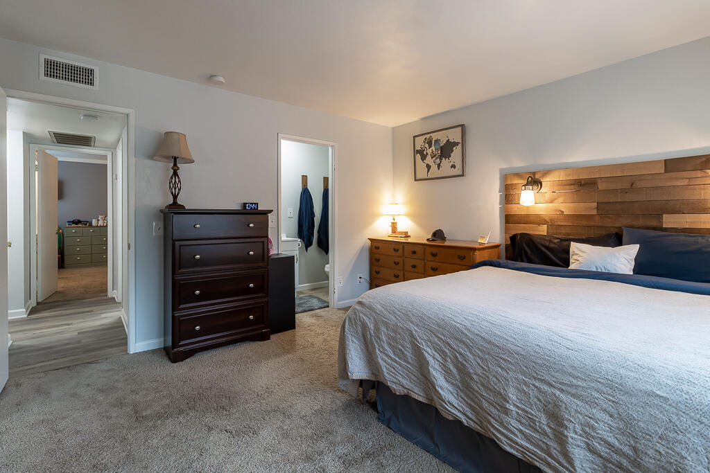 31355 The Old Road, Unit E Castaic, CA 91384 - Photo 26 of 38 a bedroom with a bed and dresser