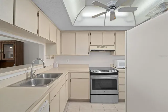 a kitchen with cabinets appliances and a sink