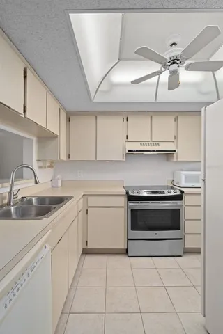 a kitchen with cabinets appliances a sink and a counter top