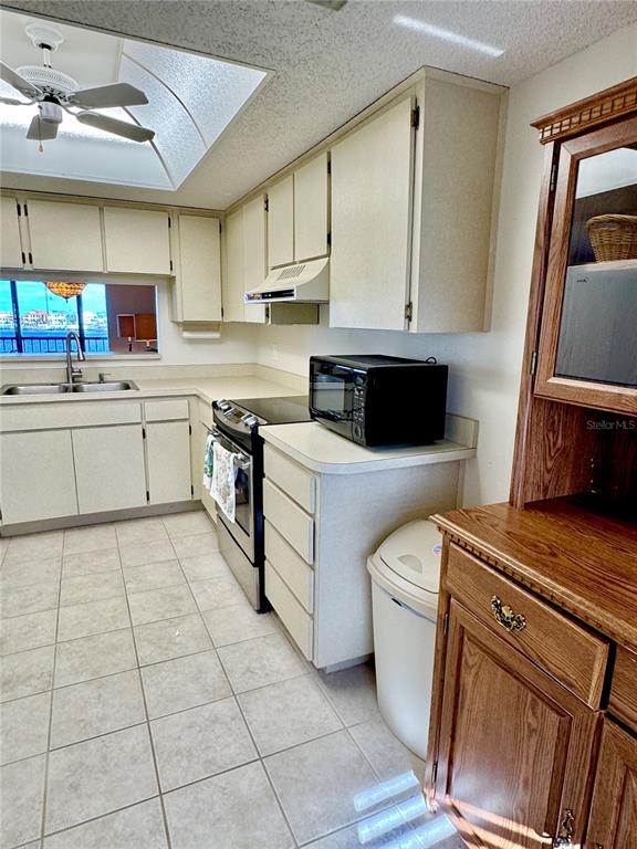 8211 Brent Street, Unit 836 Port Richey, FL 34668 - Photo 14 of 55 a kitchen with a sink a stove top oven and cabinets