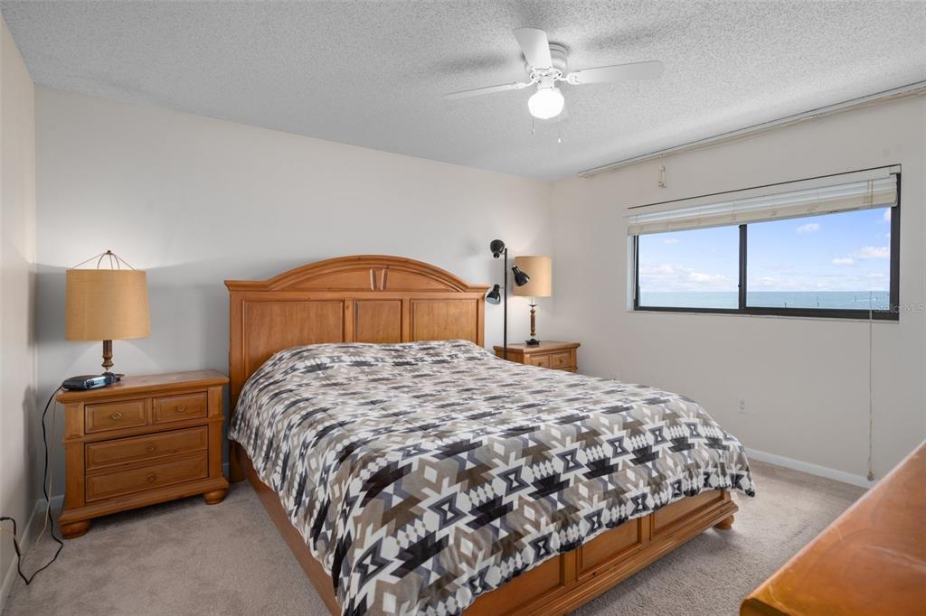 8211 Brent Street, Unit 836 Port Richey, FL 34668 - Photo 16 of 55 a bedroom with a bed and a chandelier