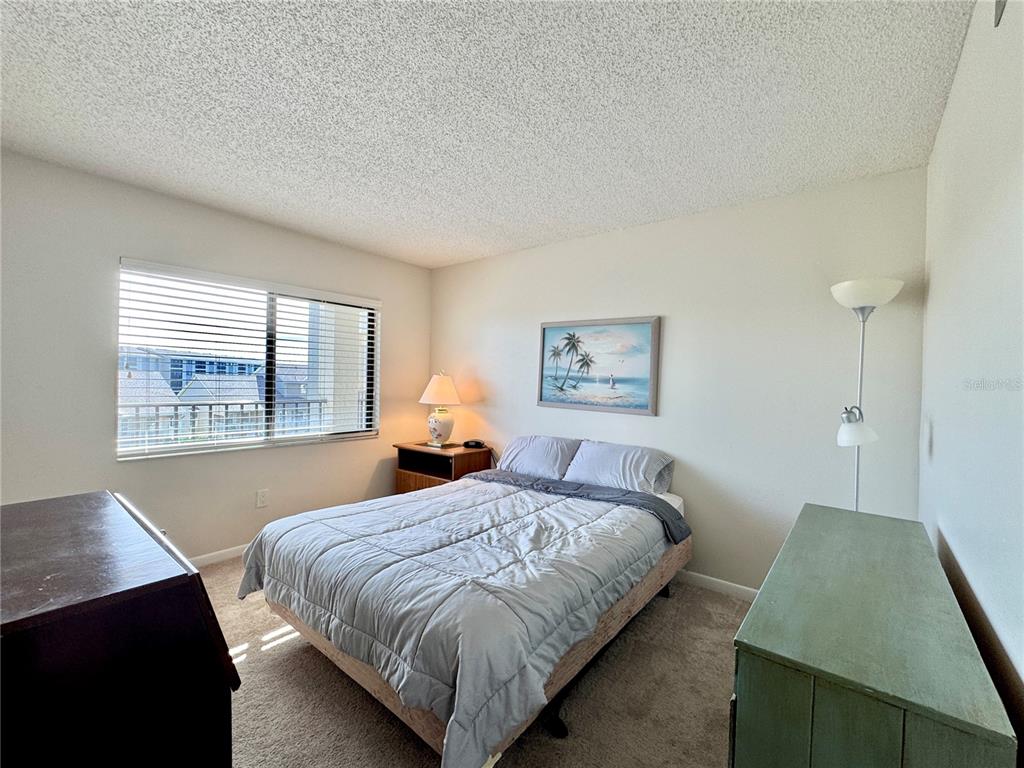 8211 Brent Street, Unit 836 Port Richey, FL 34668 - Photo 24 of 55 a bedroom with a bed and a window
