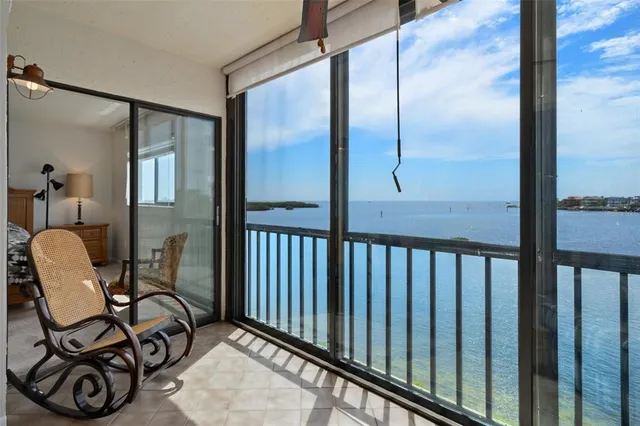 a view of swimming pool with lawn chairs and a big yard