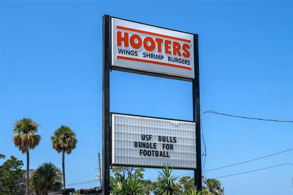 a front view of a building with table and chairs