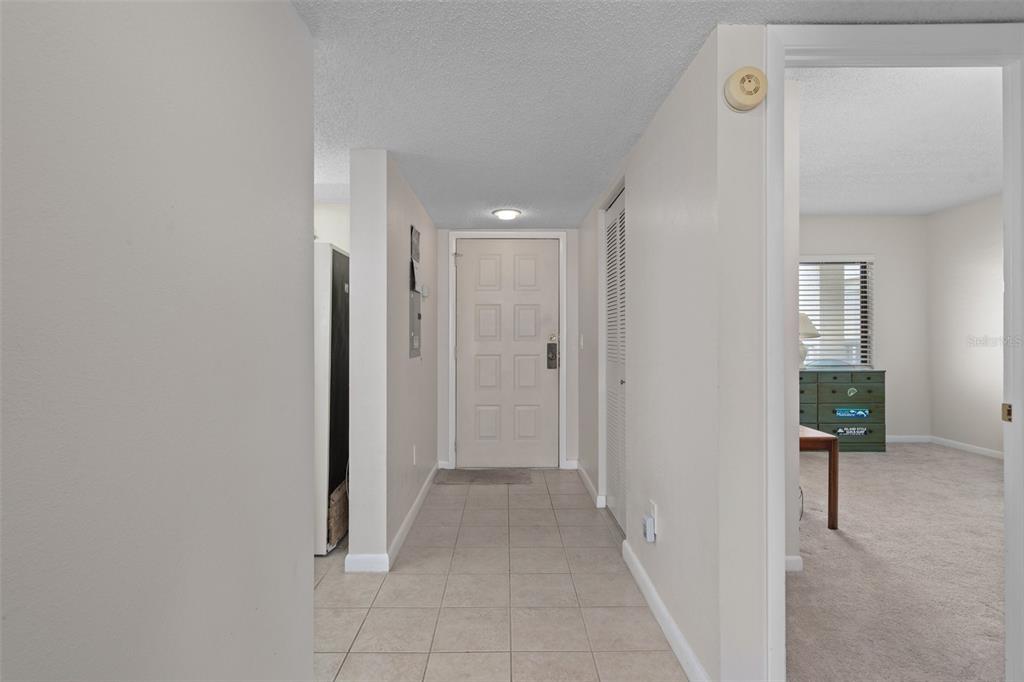 8211 Brent Street, Unit 836 Port Richey, FL 34668 - Photo 6 of 55 a view of a hallway with wooden floor and a living room